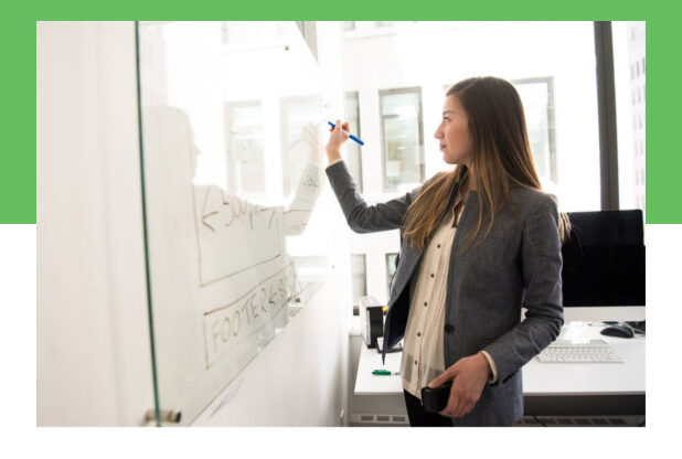 A woman whiteboarding UC trends for 2025